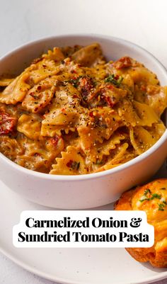 a white plate topped with pasta and muffins