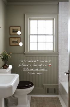 a white toilet sitting next to a sink in a bathroom with a quote on the wall