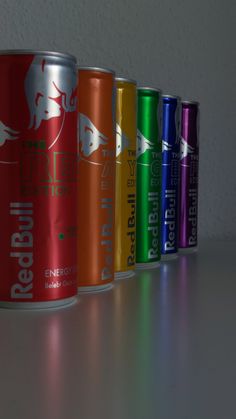 six cans of red bull energy drink lined up