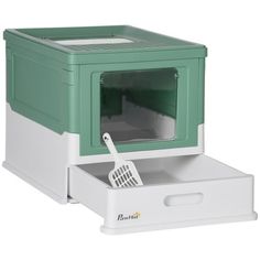 a green and white microwave oven sitting on top of a drawer with a spatula in it