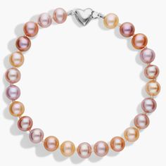 A strand of freshwater cultured pearls in varying hues of pink offers a fresh take on a classic style. Nearly round multicolor pearls are strung on a hand-knotted silk blend cord and completed with a sterling silver heart-shaped clasp. Elegant Multicolor Pearl Bracelets, Elegant Multicolor Pearl Beaded Bracelets, Elegant Single Strand Multicolor Beaded Bracelets, Pink Elegant Single Strand Beaded Bracelets, Elegant Pink Single Strand Beaded Bracelets, Pink Pearl Bracelet With Round Beads For Formal Occasions, Elegant Multicolor Single Strand Bracelet, Formal Pink Pearl Bracelet, Cultured Pearl Bracelet