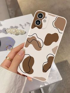 a woman holding up her phone case with an animal print on it, and the back cover