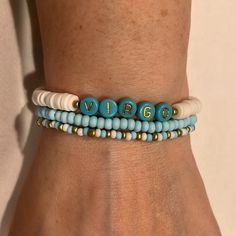 a close up of a person's arm wearing a bracelet with beads on it