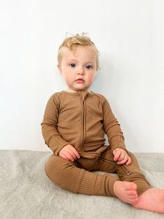 Introducing our Ribbed Zip Romper, crafted from breathable, silky smooth 95% Bamboo Viscose and 5% Spandex in custom prints. This long sleeve romper combines style, comfort, and convenience, making it a must-have for your little one's wardrobe. Key Features: Breathable & Silky Smooth: Made from 95% Bamboo Viscose and 5% Spandex, our fabric is incredibly soft and feels as luxurious as cashmere, ensuring all-day comfort. Double Zip Design: Features a double zip for easy diaper changes, providing b Fitted Long Sleeve Cotton Bubble Romper, Solid Color Cotton Ribbed Onesie, Newborn Zipper Onesie, Playful Long-sleeve Bubble Romper For Loungewear, Newborn Knit Romper, Knotted Beanie, Newborn Beanie, Oversized Blanket, Bamboo Pajamas