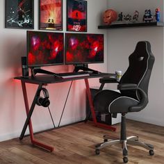 two computer monitors sitting on top of a desk