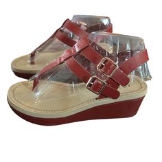 Give Off An Effortless Look For The Sunny Weather With The Bianca Wedge Sandal From Journee Collection. This Silhouette Is Fashioned With T-Strap Styling And Side Buckle Details For Extra Intrigue! Faux Leather Upper Adjustable Buckle Closures Round Open Toe Synthetic Lining Lightly Padded Footbed 1" Platform, 2¼" Covered Wedge Heel Rubber Sole Imported New In Box Size 6 Red T-strap Sandals With Ankle Strap, Red Ankle Strap T-strap Sandals, Red T-strap Sandals With Round Toe For Summer, Red Leather Wedge Sandals For Summer, Red Ankle Strap Wedge Sandals With Removable Insole, Red T-strap Sandals With Ankle Strap For Spring, Red Open Toe T-strap Sandals, Red Open Toe T-strap Sandals For Beach, Red Ankle Strap T-strap Sandals For Spring