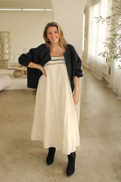 Meet our effortless and relaxed fit cotton-tiered Maxi Dress. Featuring an empire top with black trim, this flowy dress is perfect to wear alone or layered with your favorite cardigan. Annalee is wearing the size Large. Maxi Dress And Cardigan Outfit, Tiered Dress Outfit, Dress And Cardigan Outfit, White Maxi Dress Outfit, Effortless Spring Outfit, Maxi Dress Layering, Empire Top, Outfit Cardigan, Maxi Dress Outfit