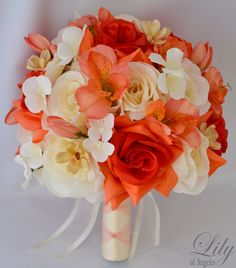 a bridal bouquet with orange and white flowers