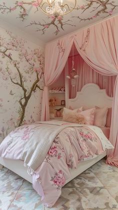 a bed with pink curtains and flowers on the wall next to a chandelier