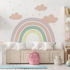 a child's room with a pink backpack and rainbow wall decal on the wall