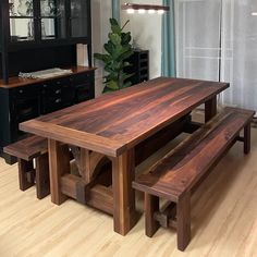 a wooden table and benches in a room