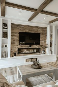 a living room with couches and a tv mounted on the wall above it's fireplace