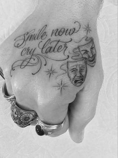 a person's hand with a tattoo saying smile now, my water on it