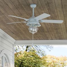 a white ceiling fan sitting on top of a porch