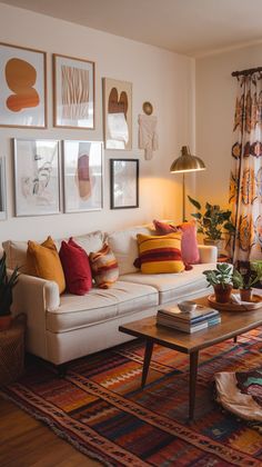 a living room filled with lots of furniture and pictures on the wall above it's coffee table