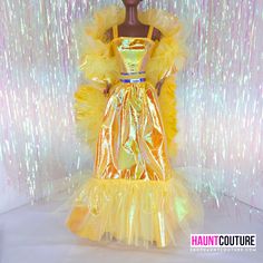 a mannequin wearing a yellow dress with gold sequins