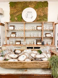 a display in a store filled with lots of cheeses and other food on top of wooden shelves