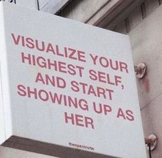 a sign on the side of a building that says visualize your highest self and start showing up as her