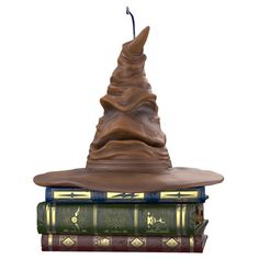 a harry potter hat sitting on top of three books