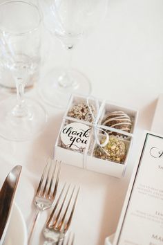 the table is set with silverware, wine glasses and napkins for guests to eat