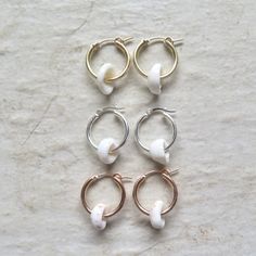 Puka Shell Hoop Earrings~ Beautiful Hawaiian puka shells adorn small tube hoops. Great gift for the beach lover! Hoops 2 X 18mm. Choose 14k gold fill, rose gold fill or sterling silver from the drop down menu. Models wearing similar designs. Shop~ http://www.etsy.com/shop/HanaMauiCreations?ref=pr_shop_more International buyers please read our shipping policies before ordering~ POLICIES~ https://www.etsy.com/shop/HanaMauiCreations/policy?ref=shopinfo_policies_leftnav White Small Hoop Earrings For Beach, Adjustable White Nickel Free Hoop Earrings, Adjustable Nickel-free White Hoop Earrings, Small Hoop White Cartilage Earrings For Gift, White Nickel-free Small Hoop Huggie Earrings, Nickel-free White Small Hoop Huggie Earrings, White Beaded Hoop Earrings For Beach, White Small Hoop Huggie Earring, White Huggie Hoop Earrings With Ear Wire