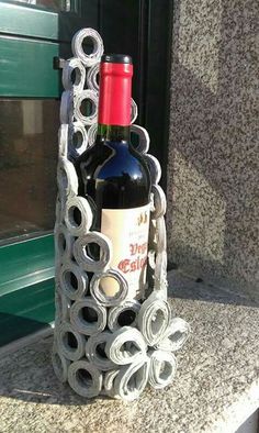 a wine bottle holder made out of rolled up paper