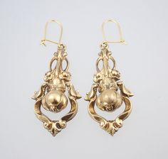 A beautiful large pair of antique Victorian 15k gold dangling pear floral earrings dating to circa 1880. These large and fabulous Victorian solid 15k yellow gold dangling earrings have a classic Victorian hollow construction for wearing comfort and have an unusual design of a wonderful 3D pear fruit with leaves wrapped around the top, framed within a dangling swinging pendulum of scrolls which shimmers and shakes beautifully whenever the head is moved, the pear suspended from a fantastic bouquet Antique Gold Earrings With Historical Design, Antique Drop Earrings With Historical Design, Victorian Yellow Gold Earrings With Intricate Design, Antique Wedding Earrings With Historical Design, Antique Yellow Gold Earrings For Wedding, Ornate Historical Design Earrings, Antique Yellow Gold Wedding Earrings, Formal Drop Earrings With Historical Design, Elegant Yellow Gold Earrings With Historical Design