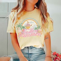 Experience the eternal sunshine and carefree vibes of summer with our Endless Summer Comfort Color Tee. Crafted for those who live for beach days and outdoor adventures, this tee is your go-to choice for endless fun in the sun. Made from premium Comfort Color fabric, our tee offers unparalleled softness and durability, ensuring you stay comfortable whether you're soaking up rays at the beach or exploring coastal trails. The classic "Endless Summer" design captures the essence of perpetual vacati Relaxed Fit Tops For Summer, Yellow Beach Graphic Tee, Spring Tropical Tops With Letter Print, Tropical Letter Print Tops For Spring, Spring Tropical Letter Print Tops, Beachy Cotton Tops For Summer Adventures, Summer Short Sleeve Tops For Summer Outings, Summer Yellow Graphic Print T-shirt, Yellow Graphic Print T-shirt For Summer