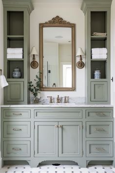 a bathroom with green cabinets and a large mirror