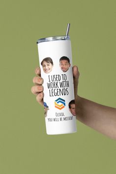 a hand holding a white tumbler with two men's faces on it and the words i used to work with legendds