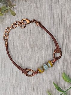 Czech Glass Sunrise Orange Blue Picasso beads with antique copper accents on antique brown leather bracelet.  This bracelet has a size fit of approximately 7 inches to 7 1/2 inches. To keep beads, leather and all other components looking their best, avoid contact with water, lotions and perfumes. To access all other items in my shop, just hit the link here: https://www.etsy.com/ca/shop/KootenayLeatherRHS If you like jewelry, check out my other Etsy shop...it's jewelry for your door!  www.etsy.co Adjustable Vintage Brown Leather Jewelry, Brown Leather Jewelry With Soldered Details, Adjustable Brown Jewelry With Patina, Adjustable Brown Patina Jewelry, Hand Wrapped Brown Leather Jewelry, Brown Leather Spiritual Bracelets, Adjustable Rustic Copper Bracelets, Spiritual Brown Leather Bracelets, Adjustable Rustic Copper Bracelet