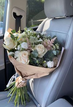 a bouquet of flowers sitting in the back seat of a car