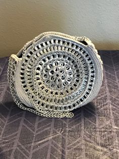 CBPursesBoutique makes handmade soda/pop tab bags.  Each bag has closures and linings.  Bags come in a variety of styles, sizes, and colors.  Each bag is one of a kind and the item pictured for each listing is the item for sale. This bag is a circular evening bag made with soda tabs and grey cotton yarn, with a black fabric lining, linked chain, and snap enclosure. Handmade Silver Shoulder Bag For Everyday Use, Silver Handmade Shoulder Bag For Everyday Use, Handmade Silver Bag For Everyday Use, Handmade Silver Bags For Everyday Use, Silver Handmade Bag For Everyday Use, Soda Tabs, Pop Tabs, Bag Silver, Soda Pop