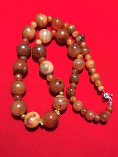 A beautiful 900 years old Pre Ankur carnelian beads necklace from Cambodia, worn by royals at that time as a luck charm. agate beads as counters. In great condition and colors of the beads are exceptional with great shine on its surface as its been continuesly used since then till now. Polished Round Carnelian Beads, Gems, And Cabochons, Carnelian Large Beads For Gifts, Carnelian Round Beads, Carnelian Polished Beads Necklace, Carnelian Beaded Necklace With Polished Round Beads, Carnelian Gemstone Round Beads, Brown Carnelian Large Beads Gems And Cabochons, Carnelian Beaded Necklaces With Polished Round Beads, Polished Carnelian Beaded Necklaces