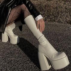 Off-white faux leather calf-height chunky platform boots! These have a slim stretchy calf with side zipper and a platform that will elongate your leg and edge up any outfit. Perfect for all the holiday stuff. Runs true to size