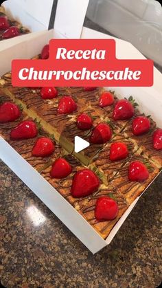 a cake with strawberries on top is in a box and has the words recei churrochescake over it