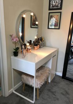 a white desk with a mirror and lights on it