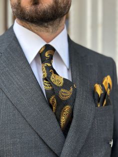 "Elevate your style with our luxurious handmade silk and microfiber blend tie and pocket square set, featuring a timeless large paisley pattern. Available in three stunning options, this set exudes sophistication and quality. Choose between: **Navy jacquard fabric with gold paisley, **Navy jacquard fabric with burnt red paisley, **Black jacquard fabric with gold paisley. The tie is designed for versatility with a 7 cm width, perfect for both formal and casual events, while the matching 24 cm x 2 Elegant Black Tie Suit With Pocket Square, Elegant Black Tie Suits With Pocket Square, Luxury Gold Suits For Business, Elegant Gold Business Suits, Formal Silk Suit And Tie Accessories With Pocket Square, Elegant Silk Mark Certified Suit And Tie Accessories, Gold Tie For Black Tie Events, Formal Silk Suit Accessories With Pocket Square, Elegant Silk Suit Accessories With Pocket Square