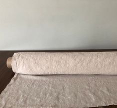 a roll of toilet paper sitting on top of a wooden table