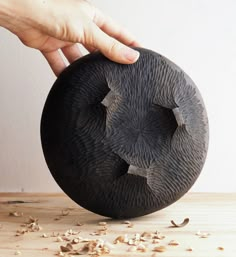 an elephant's head is made out of wood and has been carved into the shape of a ball