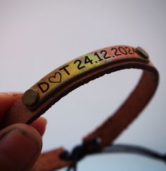 a close up of a person holding a rubber band with the word dot232 on it