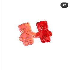 two gummy bears sitting next to each other on a white background with the same color