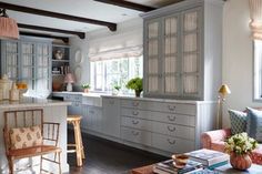 a living room filled with furniture next to a kitchen and breakfast nook area on top of a hard wood floor