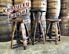 three wooden barrels sitting next to each other with the words kentucky bar set on them