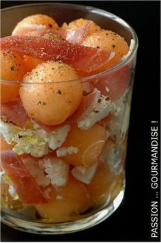 a glass filled with food sitting on top of a table