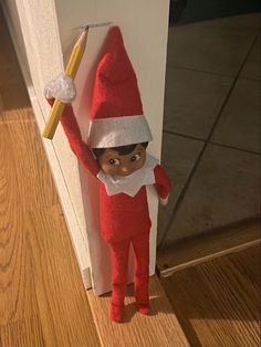 an elf with a toothbrush in his hand is standing next to a door way