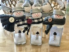 three snowmen are in bottles with buttons on them