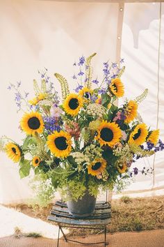 a vase filled with sunflowers sitting on top of a table