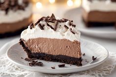 there is a piece of chocolate cake on the plate with whipped cream and chocolate shavings