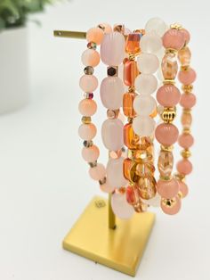 The Coco Rum Stack is a stunning and eye-catching bracelet stack that adds a subtle touch to any outfit. Its simple yet unique design will make you stand out in a playful and fun way. Lead & Nickel Free Bracelets are 'one size fits most' and are designed to fit wrists up to 7.5" comfortably. Please be aware that due to the unique and handmade nature of each product, colors, shapes, and bead sizes may vary slightly from the photos and descriptions. Trendy Stackable Wrap Bracelet With Round Beads, Trendy Adjustable Stackable Beaded Bracelets, Adjustable Trendy Rose Gold Beaded Bracelets, Trendy Adjustable Rose Gold Beaded Bracelets, Trendy Stackable Wrap Bracelet For Friendship, Trendy Stacked Pink Beaded Bracelets, Trendy Rose Gold Stackable Bracelets, Trendy Stacked Pink Bracelets, Trendy Pink Stacked Beaded Bracelets